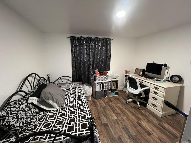 bedroom with dark wood-type flooring