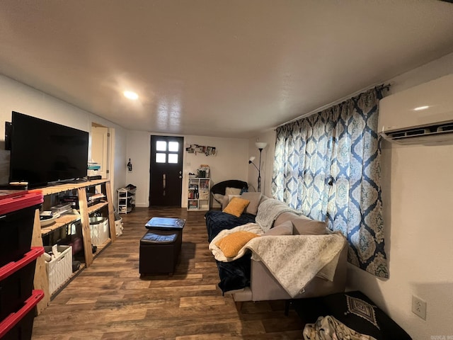 living room featuring dark hardwood / wood-style floors and a wall unit AC