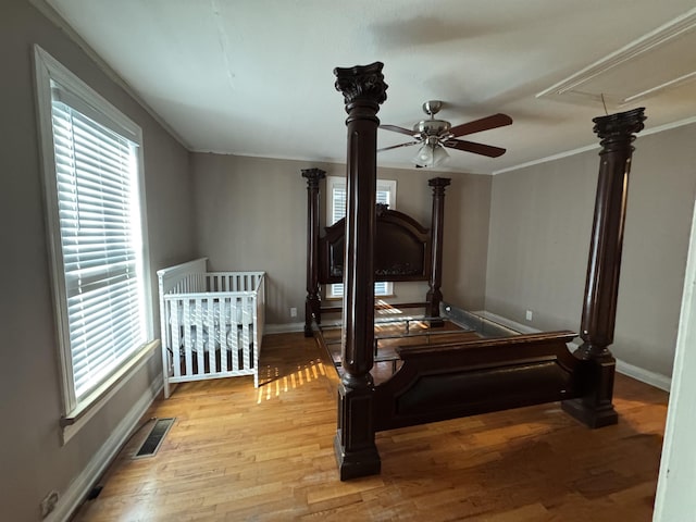 bedroom with light hardwood / wood-style floors and ornamental molding