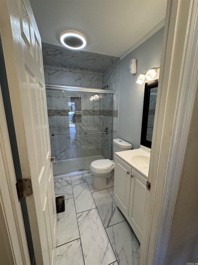 bathroom with vanity, toilet, an enclosed shower, and ornamental molding