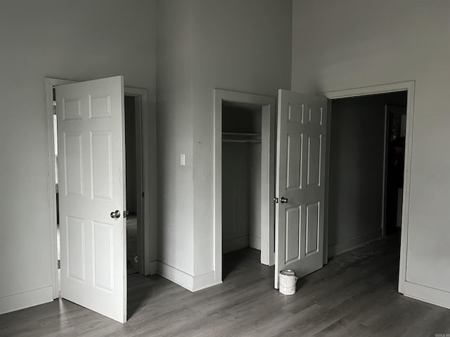 unfurnished bedroom featuring dark hardwood / wood-style flooring and a closet