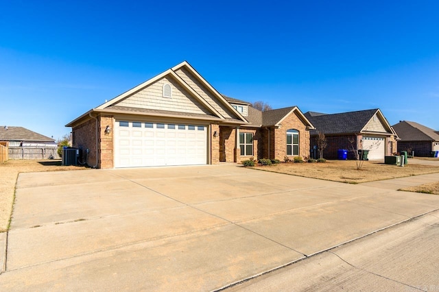 ranch-style house with a garage and central air condition unit