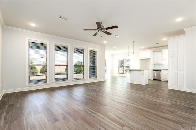 unfurnished living room featuring ceiling fan, dark wood-type flooring, and ornamental molding