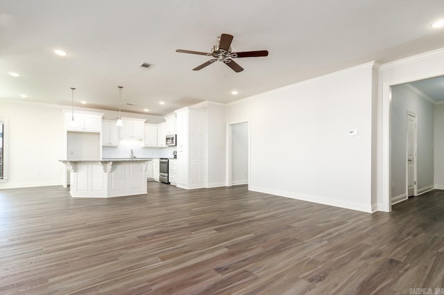 unfurnished living room featuring dark wood-type flooring, ceiling fan, and crown molding