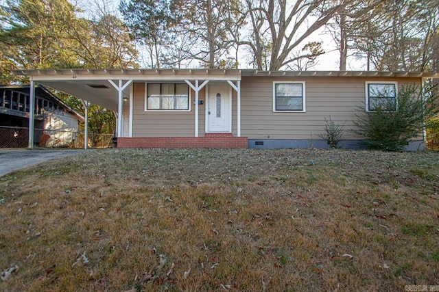 ranch-style home with a carport and a front lawn