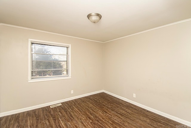 spare room with dark hardwood / wood-style floors and crown molding