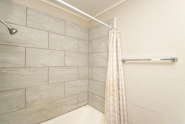 bathroom featuring shower / bathtub combination with curtain and crown molding