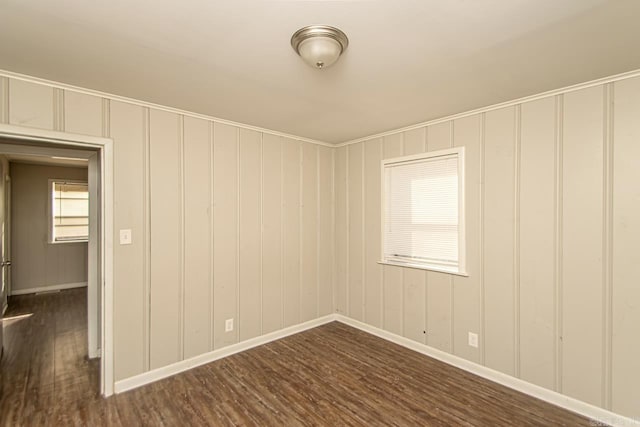 spare room featuring dark hardwood / wood-style flooring