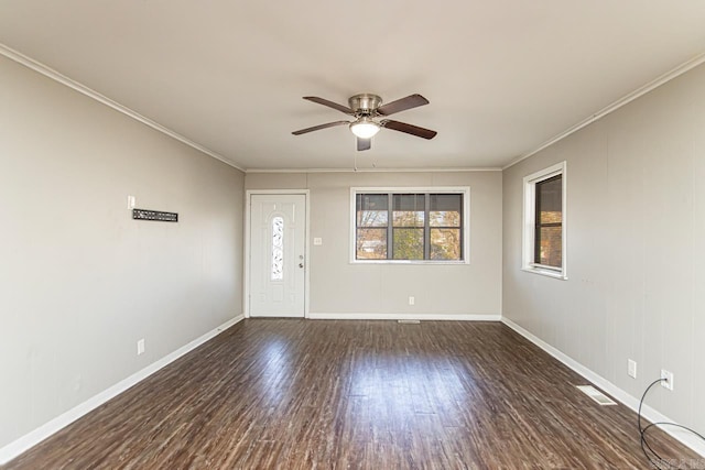 foyer with ceiling fan, dark wood-type flooring, and ornamental molding