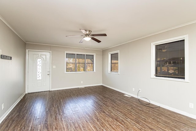 entryway with ceiling fan, crown molding, and dark wood-type flooring