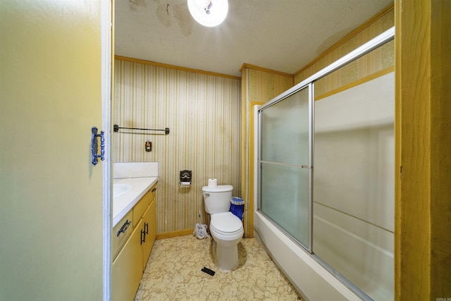 full bathroom featuring combined bath / shower with glass door, a textured ceiling, vanity, crown molding, and toilet