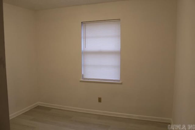 empty room with light hardwood / wood-style flooring