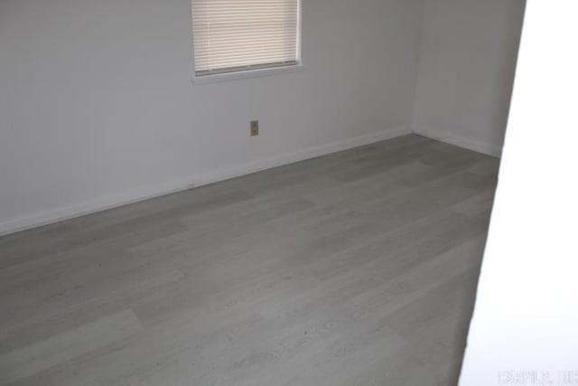 spare room featuring wood-type flooring