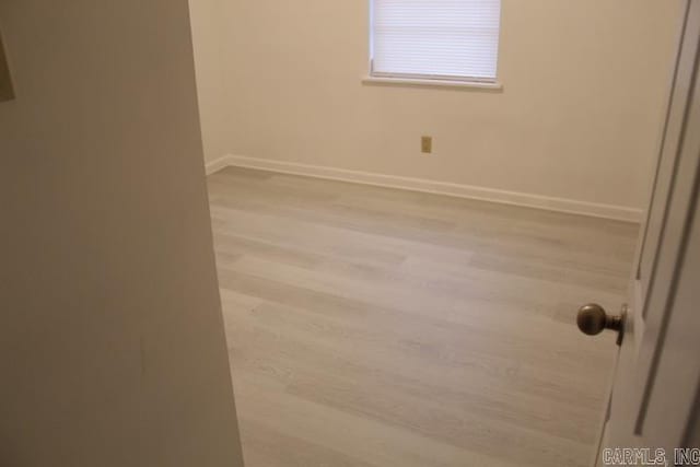 unfurnished room with light hardwood / wood-style flooring