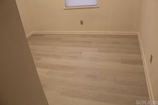 spare room with hardwood / wood-style flooring