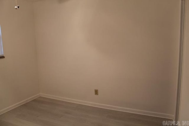 unfurnished room with wood-type flooring