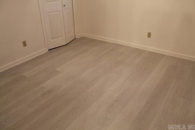 unfurnished bedroom featuring light hardwood / wood-style floors and a closet