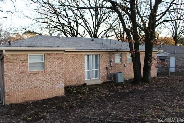 rear view of house featuring cooling unit