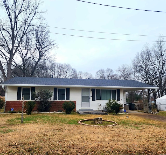 ranch-style house with a front lawn and a carport