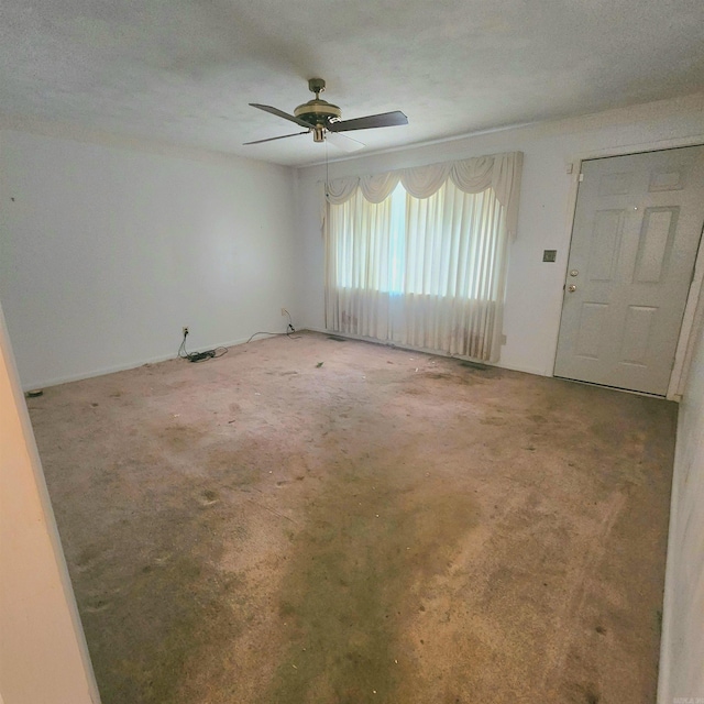 carpeted empty room with ceiling fan