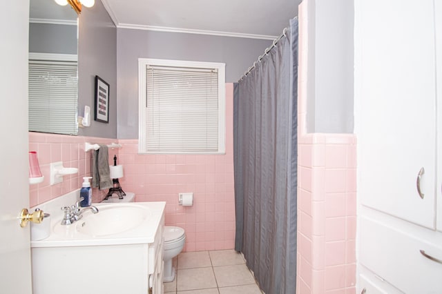 bathroom with vanity, tile patterned flooring, toilet, ornamental molding, and tile walls