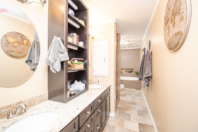 bathroom featuring vanity, toilet, a relaxing tiled tub, and ornamental molding