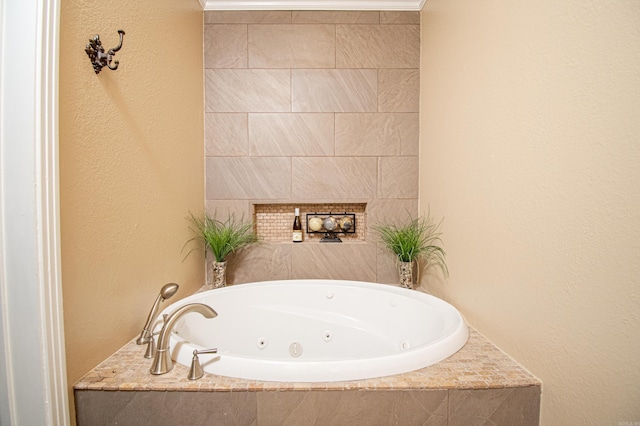 bathroom with tiled bath and crown molding