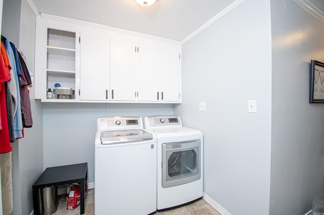 laundry area with separate washer and dryer, cabinets, and ornamental molding