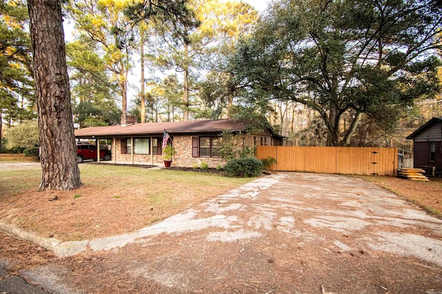 ranch-style home with a front yard and a carport