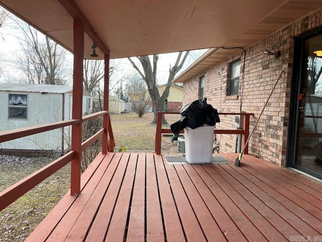 wooden terrace with a shed