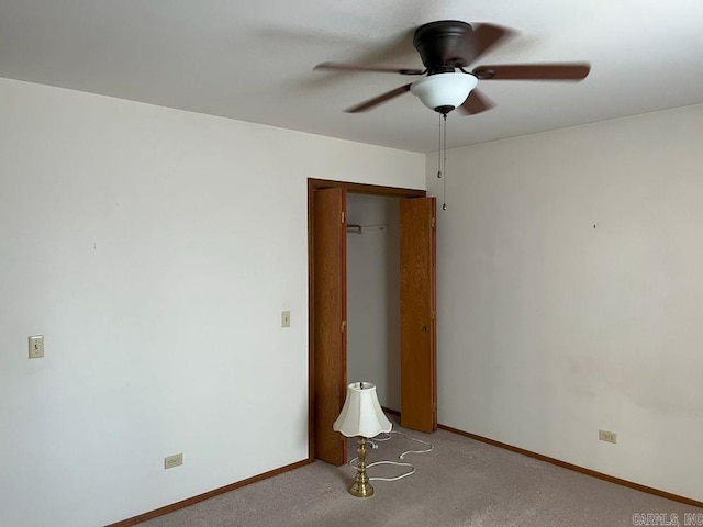 unfurnished room with ceiling fan and light carpet