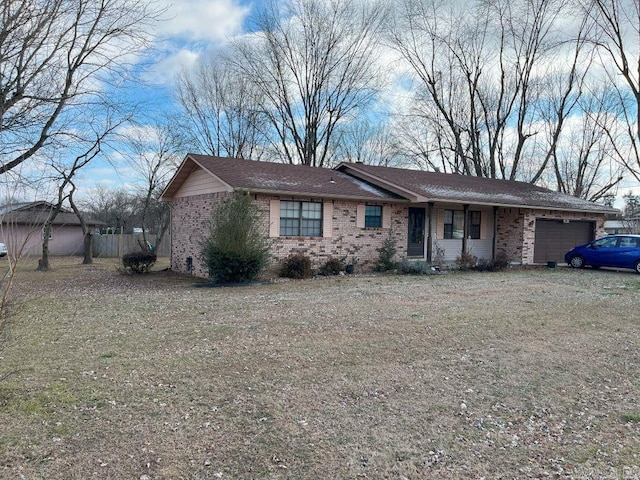 ranch-style home with a front lawn and a garage