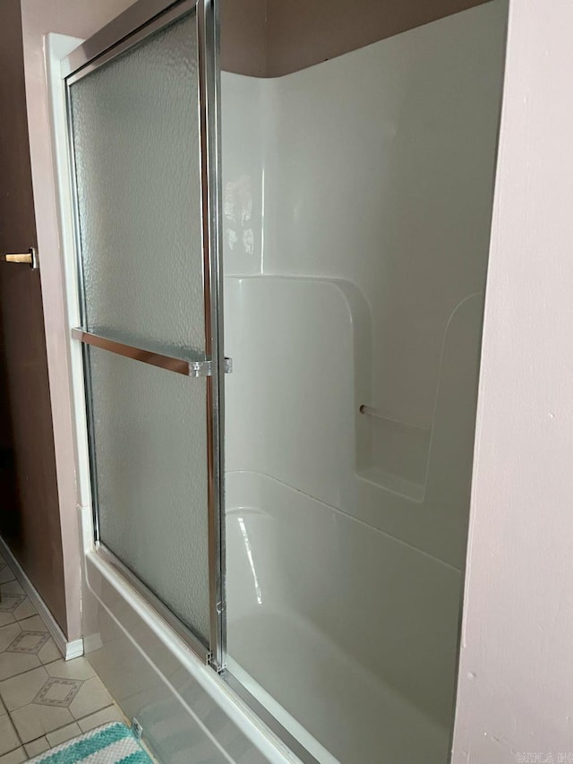 bathroom featuring tile patterned flooring and an enclosed shower