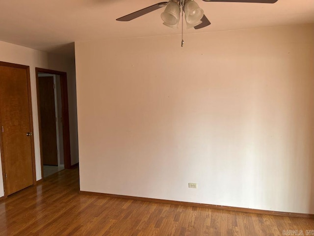 empty room featuring dark hardwood / wood-style floors and ceiling fan