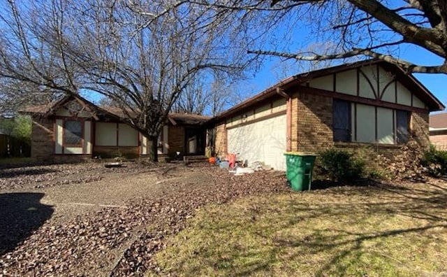 view of property exterior featuring a garage and brick siding