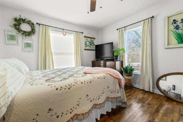 bedroom with ceiling fan and dark wood-type flooring