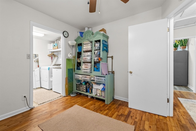 interior space featuring ceiling fan, wood-type flooring, and independent washer and dryer