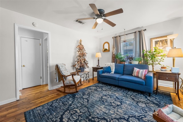 living room featuring dark hardwood / wood-style floors and ceiling fan