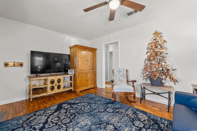 living room featuring wood-type flooring and ceiling fan