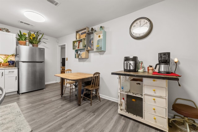 dining area with hardwood / wood-style floors