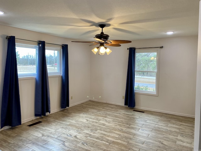 spare room with light hardwood / wood-style flooring and ceiling fan