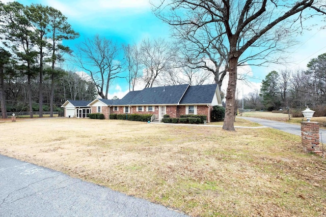 ranch-style home featuring a front yard