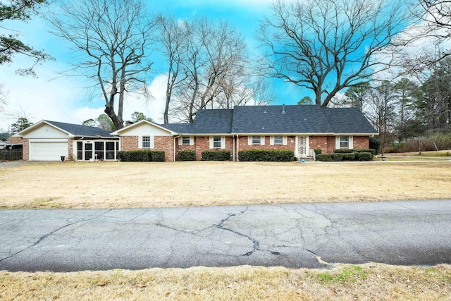 single story home featuring a front yard and a garage