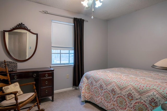 carpeted bedroom with a textured ceiling and ceiling fan