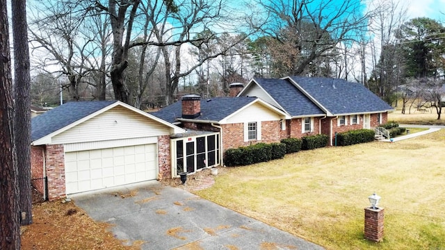 view of front facade featuring a garage, a front lawn, and a sunroom