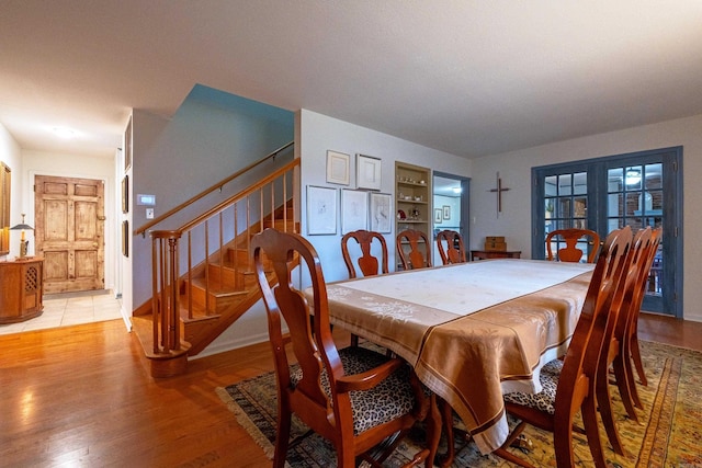 dining space with hardwood / wood-style flooring