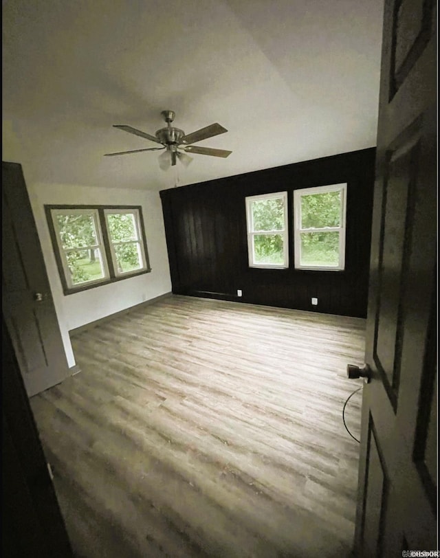 spare room with hardwood / wood-style floors and ceiling fan