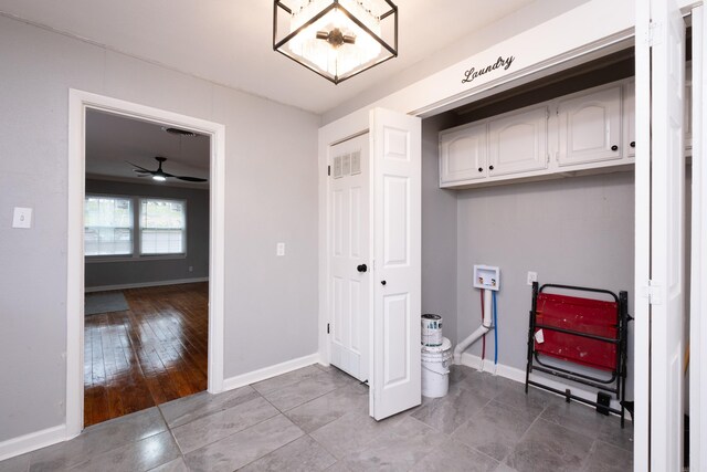 clothes washing area with cabinets, washer hookup, light tile patterned floors, and ceiling fan