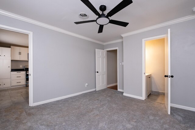 unfurnished bedroom featuring carpet flooring, connected bathroom, ceiling fan, and ornamental molding