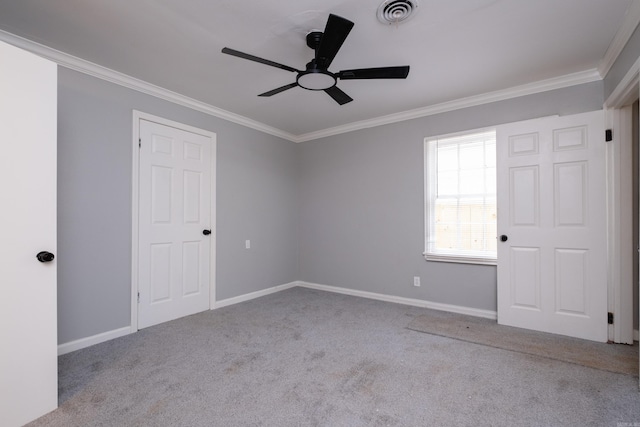 spare room with light colored carpet, ceiling fan, and ornamental molding